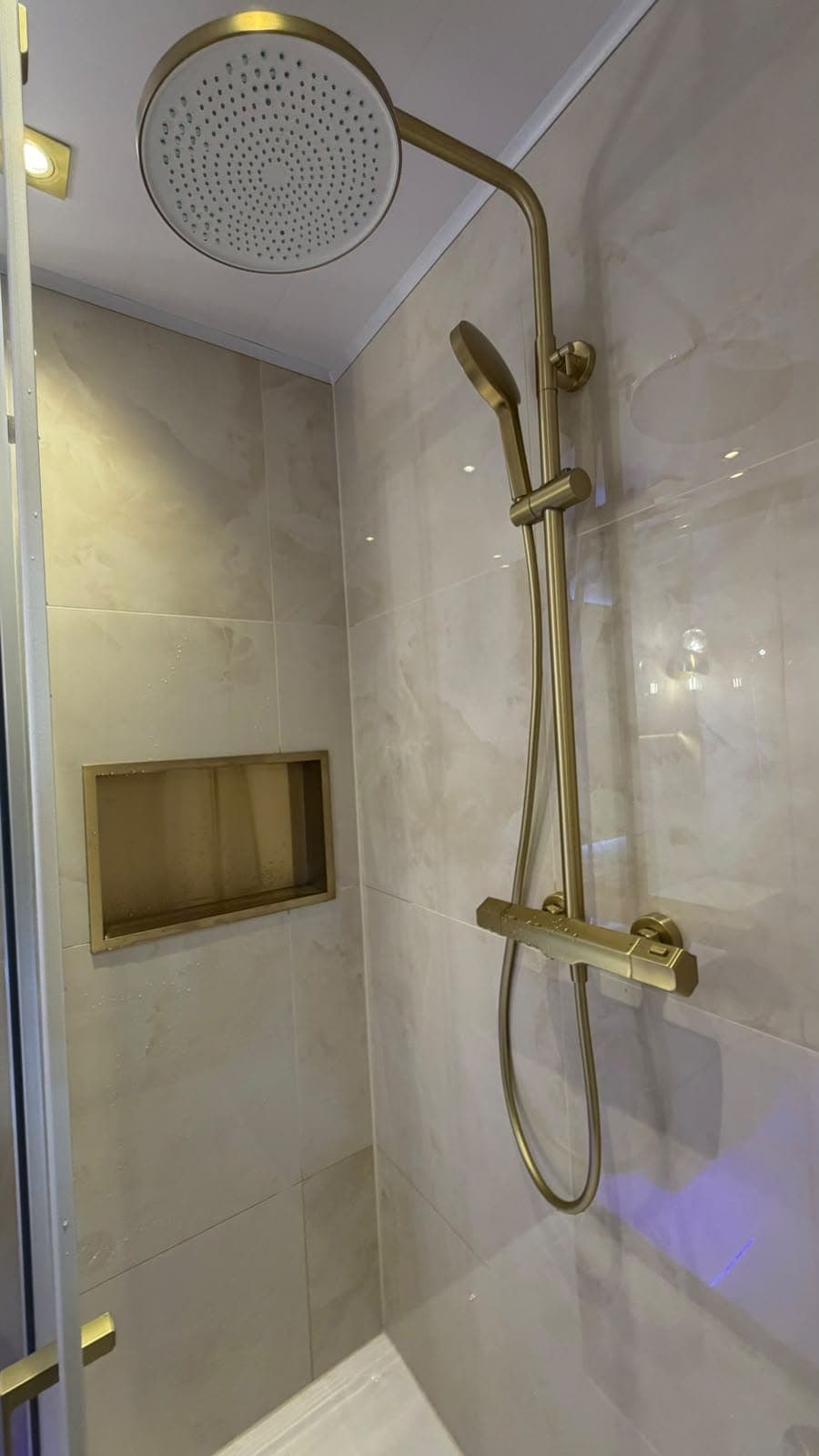 Rainfall shower with brass thermostatic controls and a recessed timber-framed shower niche