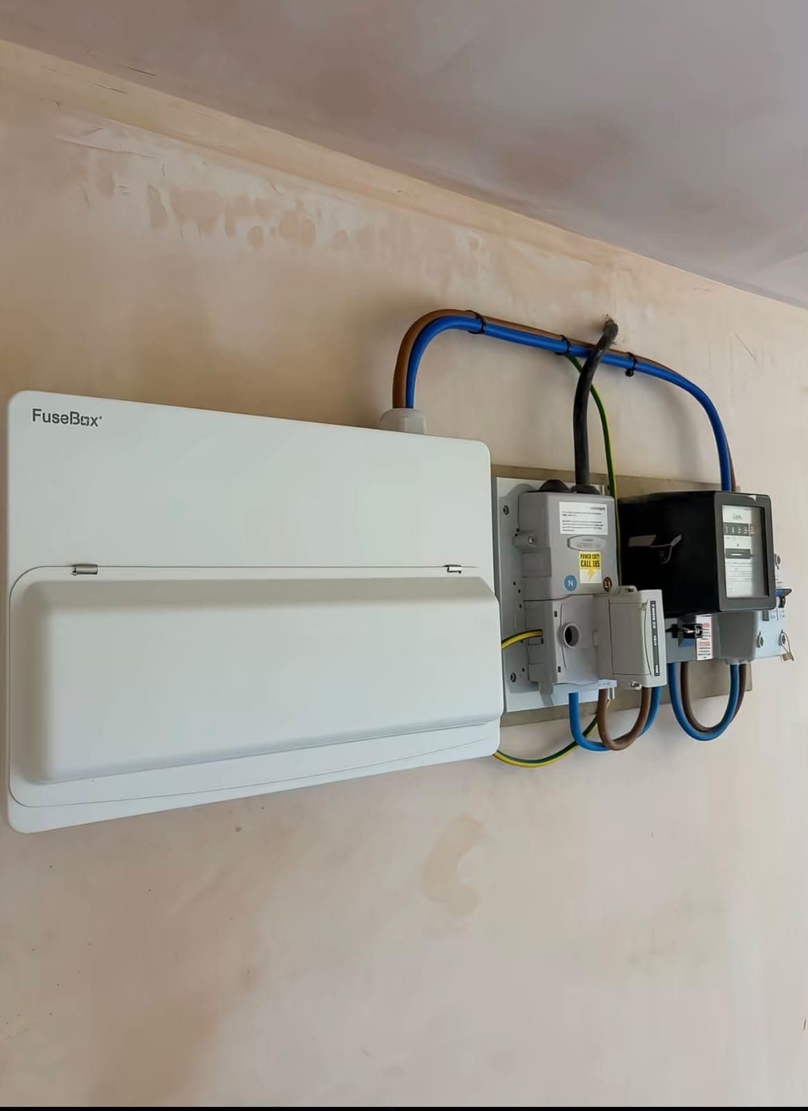 Newly installed white consumer unit with cover fitted and neat wiring