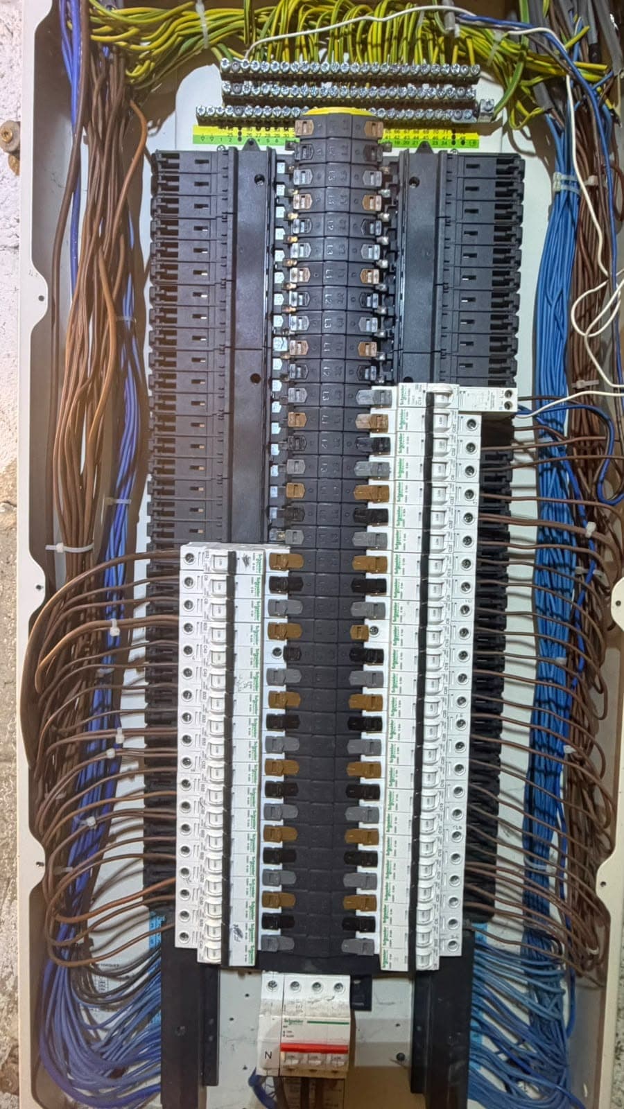 Close-up of a distribution board with multiple circuit cables connected
