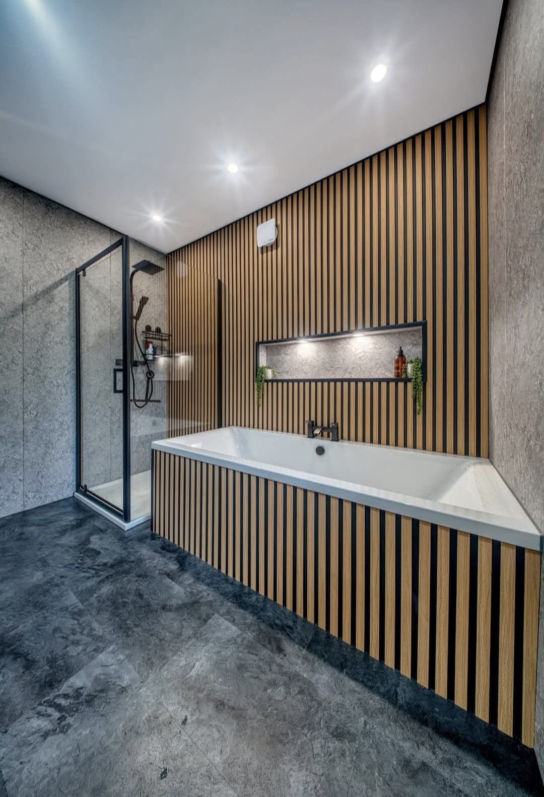 Bathroom with timber slat bath panel, recessed niche and walk-in shower
