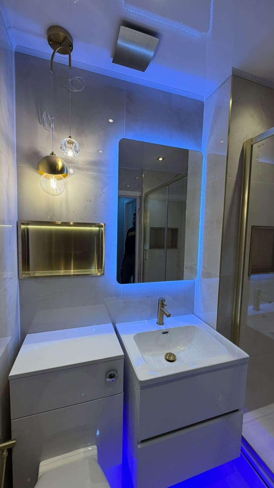 Bathroom with blue LED lighting, backlit mirror and wall-hung vanity unit